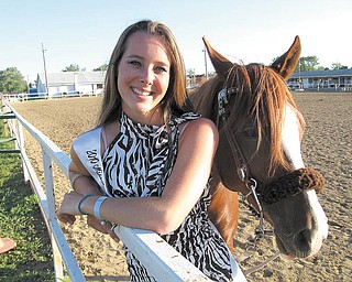 Elaine Kelley, 17, of Cortland, stands with one of her two horses, Padamay, with whom she will compete in Columbus July 30 in contesting events. Five weeks ago, another horse, Rebel, fell on her, injuring her face, shoulder, arms and legs, but she decided to compete anyway in her horse riding events two weeks ago and the Miss Trumbull County Fair contest June 28, finishing second in the queen contest and qualifying for a horse riding contest in Columbus.