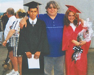 Joseph Scullen, center, is flanked by Rafael Ferrer Jr. and Christina Scullen, both 1997 graduates of Campbell Memorial High School.