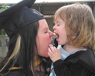 After receiving her masterÕs degree in social work from Youngstown State University, Terri Liller of Boardman shares her joy with her daughter, Harper Liller, also of Boardman..