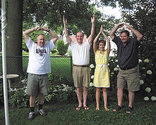 2010 Ohio State University graduate Anne Garwig of Columbus celebrates at her graduation party by forming the ÒOhioÓ pose with, from left, her father, Glen Garwig of Boardman, and her uncles, the Rev. Robert Garwig of Portland, Ore., and John Garwig of Cleveland, at the Garwig home in Boardman.