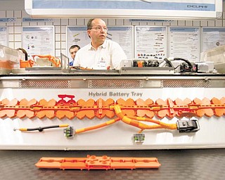 Chris Burns stands behind a reconstruction of the wiring for the battery of a Ford Focus Hybrid at the Delphi Technical Center in Champion. Burns, director of advanced engineering for the company’s electrical/electronic architecture, said Delphi has emerged as an international leader in electric vehicle innovation and is a critical component of the reorganized Delphi.