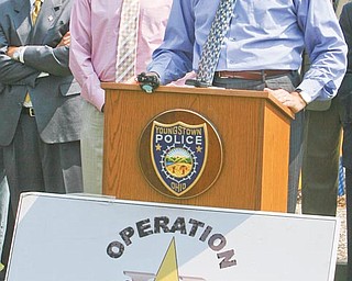 Steven Dettelbach, U.S. attorney for Ohio’s Northern District, discusses a major crime initiative for the Mahoning Valley to arrest criminals, particularly those who use handguns. To his left is Youngstown Mayor Jay Williams. The Gun Reduction and Interdiction Project will operate this summer throughout the region with the cooperation of federal officials and a dozen Mahoning Valley police and justice agencies.