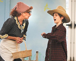 Mrs. McGregor, played by Molly Galano of Boardman, confronts Peter Rabbit, portrayed by Donny Wolford of Greenford, during a production of “Miss Beatrix Potter Presents Peter Rabbit” at the Poland branch of the Public Library of Youngstown and Mahoning County.