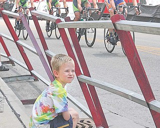 Jason Sweder from Boardman takes in The Tour of the Valley bicycling criterium in downtown Youngstown on Sunday afternoon. He was oneof many spectators who visited the downtown area to take in the annual cycling- stage event. The tour, which began Friday, was part of The Biggest Weekend of Summer celebration.