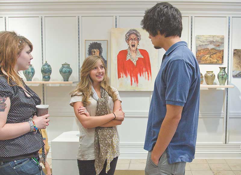 From left, Halley Snow of Youngstown, Nikki Mehle of Canfi eld and Justin Reese of Youngstown chat around their artwork displayed at the Art Outreach Gallery at Eastwood Mall. Their teacher is Kathy Young.