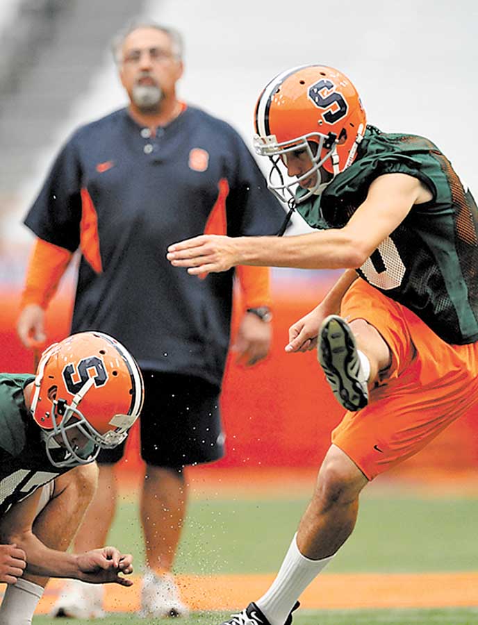 Bob Casullo watches the ball after a kick by place-kicker Jake Smith.. Photo by Frank Ordo–ez /The Post-Standard