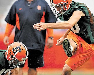 Bob Casullo watches the ball after a kick by place-kicker Jake Smith.. Photo by Frank Ordo–ez /The Post-Standard