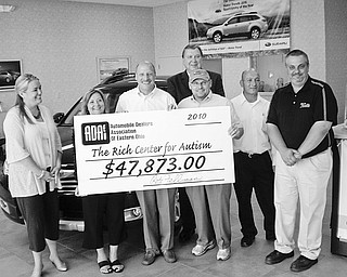 The Automobile Dealers Association of Eastern Ohio raised $47,873 for The Rich Center for Autism at Youngstown State University. The check for the record-breaking donation was presented July 7 at Boardman Subaru. Present for the ceremony were, from left to right, Tricia Perry and Phyllis Ricchuti, both of the Rich Center; Rob Fellman, chairman and new ADAEO board president, of Boardman Subaru; Steve Chos, executive vice president of the ADAEO; John Kufleitner of Columbiana Chrysler, Jeep Dodge; and Tom Levak and Steve Bott of Mark Thomas Ford.