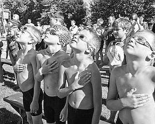 Boardman Tennis and Swim Club had its first home swim meet vs Poland Swim Club on June 30. The four boys above in the foreground are members of the 8 and under boys medley relay. They are captured during the National Anthem at the beginning of the competition. From left to right are swimmers Dean Boyd, River Flately, Siman Mascola and Max Rassega.