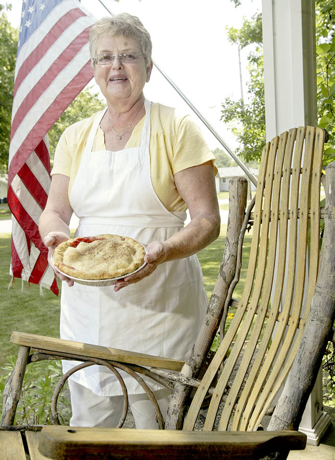 Alice Lang of Austintown shows off a pie she recently baked, appropriately standing by a rocking chair on her front porch. Last year, LangÕs cherry pie won the pie-making contest at Mahoning Valley EpilepsyÕs annual Rocking for Epilepsy Awareness. She plans to enter a pie in this yearÕs event, which is July 24 from 10 a.m. to 6 p.m. at the Austintown Cracker Barrel Restaurant..