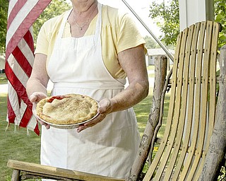Alice Lang of Austintown shows off a pie she recently baked, appropriately standing by a rocking chair on her front porch. Last year, LangÕs cherry pie won the pie-making contest at Mahoning Valley EpilepsyÕs annual Rocking for Epilepsy Awareness. She plans to enter a pie in this yearÕs event, which is July 24 from 10 a.m. to 6 p.m. at the Austintown Cracker Barrel Restaurant..