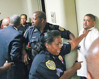 Youngstown police use force to break up a melee Wednesday morning in the hallway of the Youngstown Municipal Court in City Hall. The fight began between the friends and family members of murder suspect Melvin Shaw and those of shooting victim Tracee Banks. Shaw was arraigned before the melee.