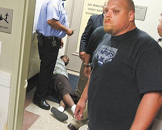 Wade Shaw, 35, of Youngstown, is shown on the ground after Youngstown police shocked him with a Taser for his involvement in a melee outside Youngstown Municipal Court. Shaw was charged with disorderly conduct, assault and resisting arrest and is in Mahoning County jail. The relationship of Wade Shaw and Melvin Shaw wasn’t clear.