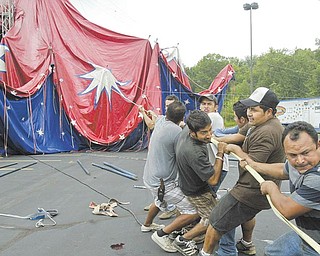 Circus hands raise the big top as Carson and Barnes Circus sets up in the parking lot of Eastwood Field in Niles on Wednesday.