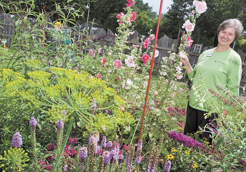 Horticulture Educator Anita Wesler among the many flowers on display at Fellows Riverside Garden.