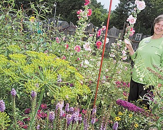 Horticulture Educator Anita Wesler among the many flowers on display at Fellows Riverside Garden.