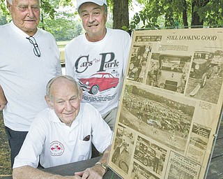The club had dubbed its Sunday event “Cars in the Park,” and this is the 32nd year it has sponsored the showing of antique vehicles. Posing with a 1979 Vindicator story about the club are, in front, Pete Draia of Youngstown, and in back, Joe Phillips of Boardman, left, and Dave Bayowski of Mineral Ridge.