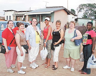 Local nurses, known as the Dream Team, visited a village with other guests while on a medical mission to Ghana led by Dr. Michael Obeng, head of plastic and reconstructive surgery at St. Elizabeth Health Center in Boardman. From left, Angela Lee of Mineral Ridge, Roberta Hamilton of Hubbard, Glenda Bell-Golec of Poland, Tatiana Blanchard, a medical student from Florida, Kathleen Fimognari of Poland, Juanita Combs of Boardman and Joyce Obeng, Dr. Obeng’s sister, of Ghana.