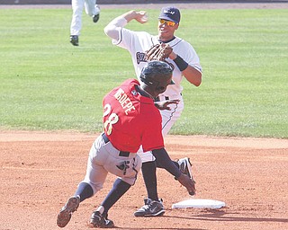 Scrappers infielder Aaron Fields fi res to first base as Spikes baserunner Gift Ngoepe tries to break up the play in Sunday’s game at Eastwood Field in Niles.