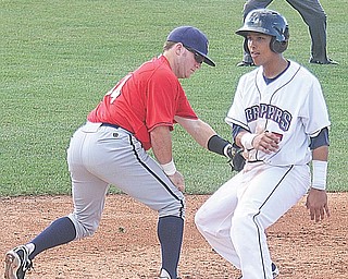 Scrappers baserunner Kevin Fontanez beats the tag of Spikes infielder Matt Curry during Sunday’s game in Niles.