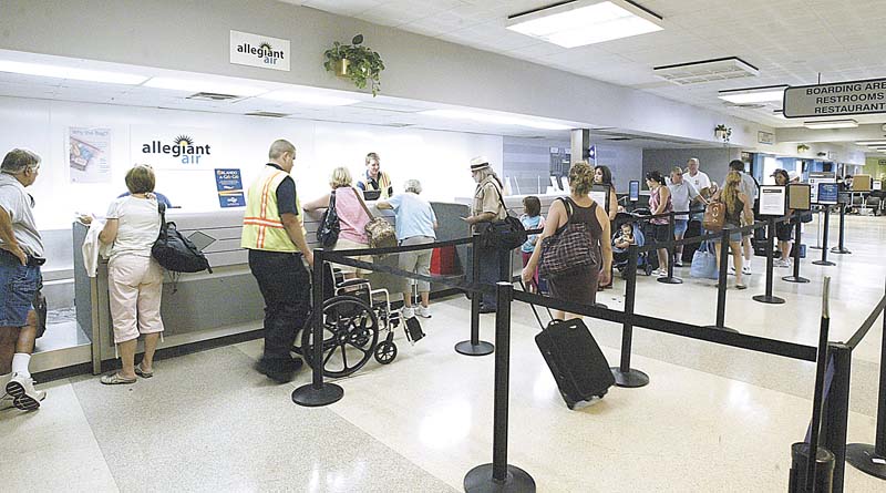Passengers wait to check in at the Youngstown Warren Regional Airport. A market survey points out that the top six flight destinations for Mahoning Valley residents are in tourist areas Ñ Orlando, Las Vegas, Tampa, Fort Lauderdale, Fort Myers, and Nashville..