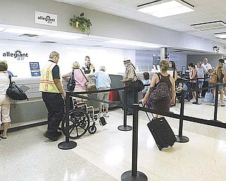Passengers wait to check in at the Youngstown Warren Regional Airport. A market survey points out that the top six flight destinations for Mahoning Valley residents are in tourist areas Ñ Orlando, Las Vegas, Tampa, Fort Lauderdale, Fort Myers, and Nashville..