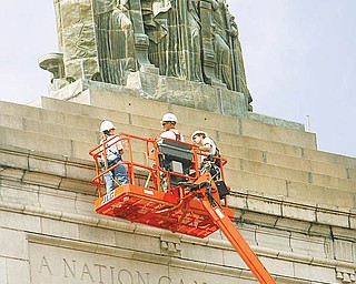 Mahoning County commissioners are expected to reallocate $177,000 Wednesday to remove and store this statue from the top of the county courthouse on Market Street..