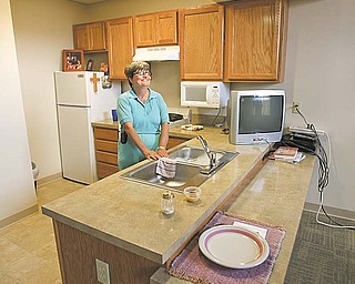 The YWCA showcased the $10 million renovation of its nearly century-old building at 25 W. Rayen Ave., Youngstown, with the first 10 of 30 apartments having been completed there in mid-July. At right, Eileen Kinnard showed off her new third-floor apartment to reporters Monday. The project also includes renovations to the first floor, which will likely feature an Internet cafŽ, and installation of a new roof.