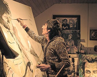 Ronnie Wood, guitarist with the legendary rock group The Rolling Stones, paints a self-portrait. An exhibition of his artwork opens Sept. 21 at the Butler Institute of American Art, Wick Avenue, Youngstown.