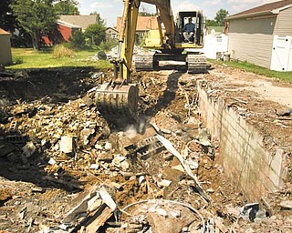 A blighted house at 497 Sexton St. is demolished, to the delight of the neighbors. Pusateri Excavating of East Liverpool tore down the house Tuesday.
