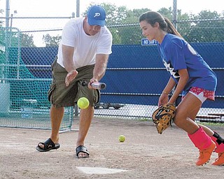 Poland’s Dani Rutana, right, practices fi elding a bunt hit by coach Chuck Masluk during practice North Elementary fi elds on Tuesday. Poland’s 11-12 softball all-stars play in the Little League Central Region tournament in Carthage, Mo., starting Saturday.