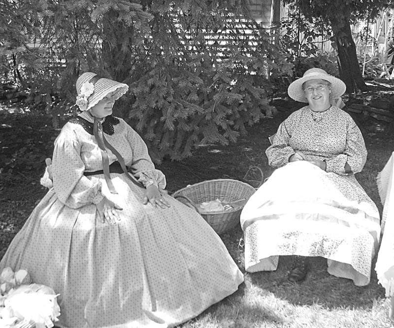 What looks like two ladies who have stepped out of the past are really members of the Ohio Volunteer Infantry Co. D. They found a little shade to sit in as they displayed the clothing style of early American Women. The volunteers, part of a “Living History Family,” will explain the roles of early families and other interesting facts for Niles Historical Society’s “Heritage Day,” which will be Sunday.