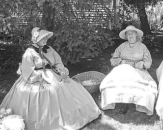 What looks like two ladies who have stepped out of the past are really members of the Ohio Volunteer Infantry Co. D. They found a little shade to sit in as they displayed the clothing style of early American Women. The volunteers, part of a “Living History Family,” will explain the roles of early families and other interesting facts for Niles Historical Society’s “Heritage Day,” which will be Sunday.