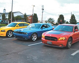 These three cars are owned by members of one family. The 2007 Dodge Charger Super Bee belongs to Chuck Sheffield; the 2010 Dodge Challenger is owned by Mary Sheffield; and the 2006 Daytona Go ManGo! Charger is their son Michael's. The picture was taken at the A&W in Boardman during the weekend of the LX Nationals.