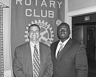 Lives reconstructed: After traveling to Ghana with five surgical nurse volunteers to perform reconstructive surgeries and to teach local doctors the procedures, Dr. Michael K. Obeng, at right, a plastic surgeon at St. Elizabeth Boardman Health Center, spoke of his experiences during a meeting of Youngstown Rotary Club. Obeng, also the founder and CEO of R.E.S.T.O.R.E. Worldwide Inc., told how the reconstructive procedures helped the poor with congenital or accidental deformities, who were shunned by families and the public, to become contributing citizens of Ghana. Obeng holds academic appointments at several institutions, including NEOCOM at Rootstown and the University of Pittsburgh. Sharing a moment with the speaker is Steve Kristen, Rotary Club president.