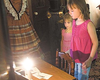 Megan, 3, and Meredith Blair, 8, of Mineral Ridge explore the upstairs master bedroom at the Ward-Thomas Museum during Heritage Day.