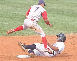 Williamsport’s Ceasar Hernandez (7) leaps over Mahoning Valley’s Jesus Aguilar as Aguilar tries to break up a double play during Sunday’s game at Eastwood Field in Niles. The Scrappers lost their second game in as many nights to the Crosscutters, who won 5-3.