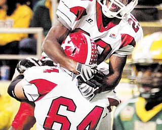 Youngstown State wide receiver Dominique Barnes is hoisted in the air by Penguin guard Eric Rodemoyer (64) after scoring the winning touchdown in last season’s game against North Dakota State University. On Monday, the two seniors were named to the Missouri Valley Football Conference’s preseason team.