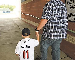 Luke Holko walks out with his dad Chad Holko at a Monday news conference announcing Luke Holko Day. Luke will be included in a team set of baseball cards given out during Sunday’s Mahoning Valley Scrappers game.