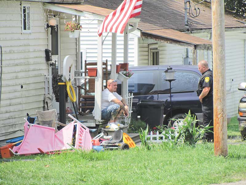 A Newton Falls police officer stands guard Wednesday in front of the house on Trumbull Court in Newton Falls where a 4-year-old boy died from a gunshot wound. The boy died Tuesday, apparently after accidentally shooting himself.