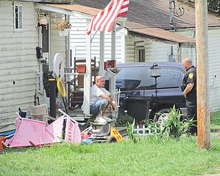 A Newton Falls police officer stands guard Wednesday in front of the house on Trumbull Court in Newton Falls where a 4-year-old boy died from a gunshot wound. The boy died Tuesday, apparently after accidentally shooting himself.