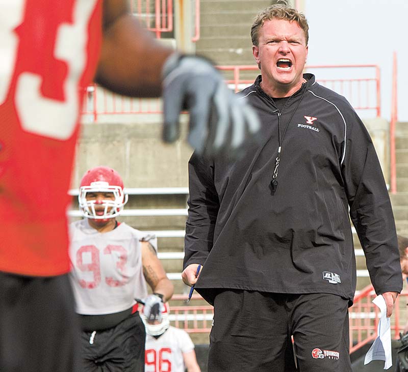 Youngstown State football coach Eric Wolford gets his point across during a spring practice at Stambaugh Stadium. Wolford has brought in 36 new players to the program since taking over.