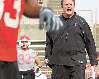 Youngstown State football coach Eric Wolford gets his point across during a spring practice at Stambaugh Stadium. Wolford has brought in 36 new players to the program since taking over.