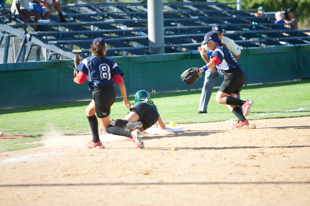 Jenna Schettler dives back to third safely after attempting to steal home during the 2010 World Series of Little League Softball, Central vs. Latin America. Central went on to win the game, 7-4.