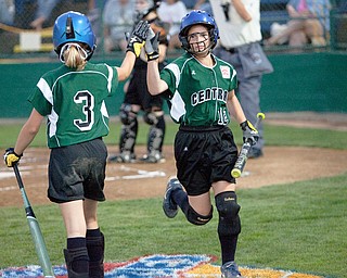 Claire Testa (3) and Maddie Rowe (12) high-five during the World Series of Little League Softball in Portland, Ore., July 13th, 2010. The team from Poland, OH went on to beat the team from Brenham, TX, 5-4.