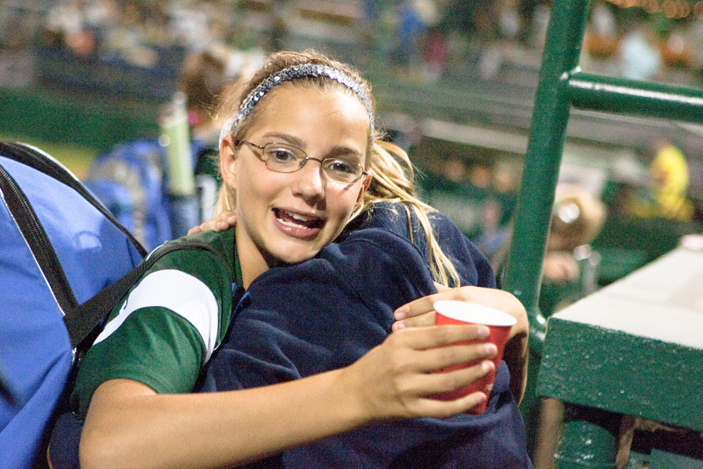 Kristyn Svetlak gets a congratulatory hug after her team wins their first game at the World Series of Little League Softball in Portland, Ore., July 13th, 2010. The team from Poland, OH beat the team from Brenham, TX, 5-4.
