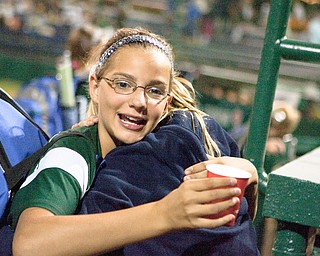 Kristyn Svetlak gets a congratulatory hug after her team wins their first game at the World Series of Little League Softball in Portland, Ore., July 13th, 2010. The team from Poland, OH beat the team from Brenham, TX, 5-4.