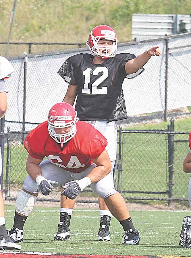 Youngstown State quarterback Kurt Hess (12) makes a call before the snap during a recent practice at Stambaugh Stadium. Hess is the frontrunner for the starting job when the season opens Sept. 4 at Penn State.