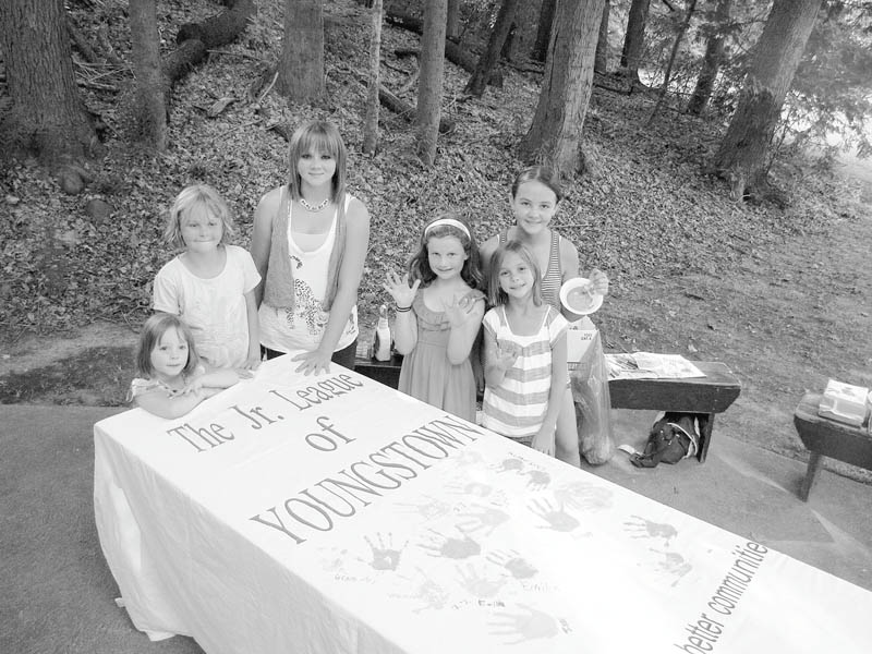 Daughters of Junior League of Youngstown members took park in a community service project while attending a membership Appreciation Day picnic recently at Mill Creek Park. Proud of their handiwork after leaving a colorful handprint on a banner prepared by the league are in front, from left, Elizabeth Siembida, Grace Aey, Lilly Aey, Ava Wilson, and Emilia Aey, in back, Isabel Aey. 