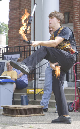 LISA-ANN ISHIHARA | THE VINDICATOR..Erik Kloeker of "The Pickled Brothers" juggles during a teaser act at the Northside Farmers Market for upcoming performances on the corner of Elm St and Illinois Ave, across from Wick Park (in front of First Unitarian Universalist Church).